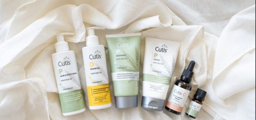 Assorted Cutis hemp seed oil skincare products arranged on a white fabric background, ready for use or display.